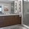 bathroom with large mirror and walk-in shower