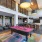 a lounge area with a pool table and chairs