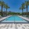 swimming pool with lounge chairs and trees in the background