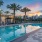 swimming pool with lounge chairs and trees in the background